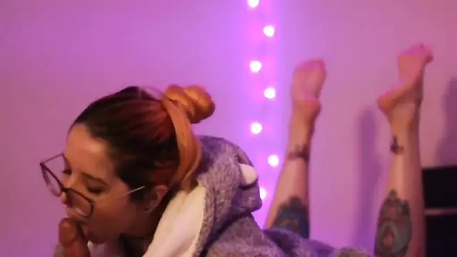 Redheaded chick with glasses gives a Brazilian blowjob to a guy before bedtime